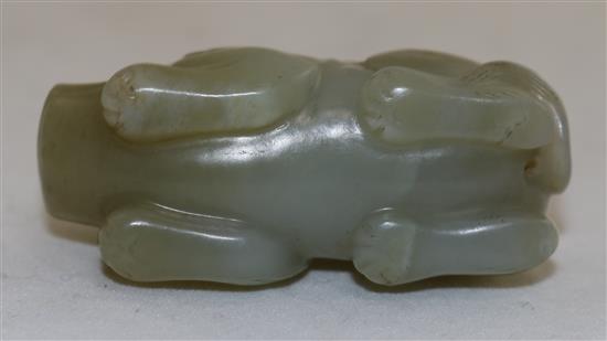 A Chinese pale celadon jade figure of a recumbent pig, 19th century, 5.6cm